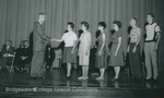 Bridgewater College, Photograph of Dr. John W. Boitnott with a line of students on stage, undated by Bridgewater College