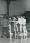 Bridgewater College Women's basketball team captains Patricia Riffle and Sharon Will shaking hands with opposing team, circa 1974 by Bridgewater College