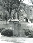 Bridgewater College, Student sitting on college entrance gate, undated by Bridgewater College