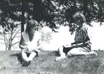 Bridgewater College, Wendy Wade and Carolyn Magee studying on lawn, May 1986 by Bridgewater College