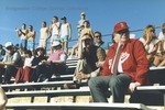 Bridgewater College, President Wayne F. Geisert sitting on bleachers watching baseball game, 1986 by Bridgewater College