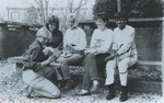 Bridgewater College, Group of students sitting on a bench looking at photographs, circa 1985 by Bridgewater College