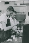 Bridgewater College, Michael Cox and an unidentified student work in the chemistry lab, circa 1959 by Bridgewater College