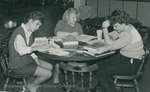 Bridgewater College, Photograph of three students studying, circa 1985 by Bridgewater College