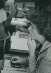 Bridgewater College, Student with a book and calculator in a BC classroom, undated by Bridgewater College
