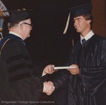 Bridgewater College, An unidentified student is presented his diploma at commencement, 1982 by Bridgewater College