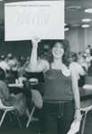 Bridgewater College, Student holds up a Daleville Hall sign at Pre-Orientation Day, 14 May 1983 by Bridgewater College
