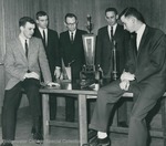 Bridgewater College, Group portrait of the 1962-1963 Debaters staring at their trophies by Bridgewater College
