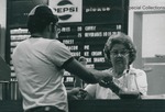 Bridgewater College, A. Philpot (photographer), A woman serving ice cream to a student in a beanie in the snack bar, undated by A. Philpot