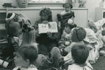 Bridgewater College, A student reading a book to costumed pre-schoolers at Halloween, Oct 1983 by Bridgewater College