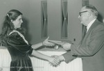 Bridgewater College, Photograph of Darla Kay Bowman receiving the Dr. Wayne Geisert Scholarship from Dr. Geisert, possibly 1989 by Bridgewater College