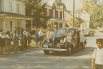 Bridgewater College, Alpha Psi women on the fenders of a car at Homecoming, 1969