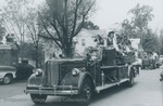 Bridgewater College, cheerleaders riding a firetruck in the Homecoming parade, 4 Oct 1980