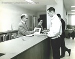 Bridgewater College, Orland Wages checking out a book to a student at the new Alexander Mack Memorial Library, circa 1964 by Bridgewater College