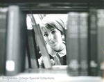 Bridgewater College, Student, Nancy Hall, through shelf in the Alexander Mack Memorial Library, circa 1968 by Bridgewater College