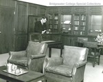 Bridgewater College, Alexander Mack descendant J. Howard Mack Jr. looks at Alexander Mack Sr. Bible in newly opened Brethren Room, 1964 by Bridgewater College