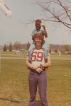 Bridgewater College, A boy with a balloon on an older boy's shoulders at the May Day festival, 1971
