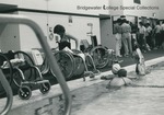 Bridgewater College, A woman smiles as she moves in her wheechair by the side of a class in the Nininger Hall swimming pool, undated by Bridgewater College