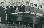 Bridgewater College, Portrait of male and female quartets singing around a piano, 1960-1961 by Bridgewater College