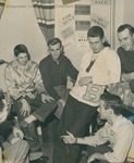 Bridgewater College, Group of men conversing in a residence hall room where handbills are displayed, circa 1951 by Bridgewater College