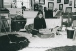 Bridgewater College, Student types sitting on a rug in her residence hall room, undated by Bridgewater College