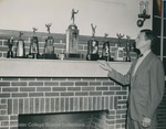 Bridgewater College, Photograph of Doc Jopson admiring his teams' trophies, 1951 by Bridgewater College