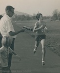Bridgewater College, Photograph of Small College Champ Doug Coleman running while Coach Harry G. M. (Doc) Jopson clocks, probably early 1970s by Bridgewater College