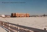 Bridgewater College, Wakeman Hall and the College Farm barn across a snowy field, 1987 by Bridgewater College